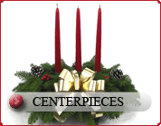 Christmas wreath centerpiece with red taper candles and pine cones by golden bow for